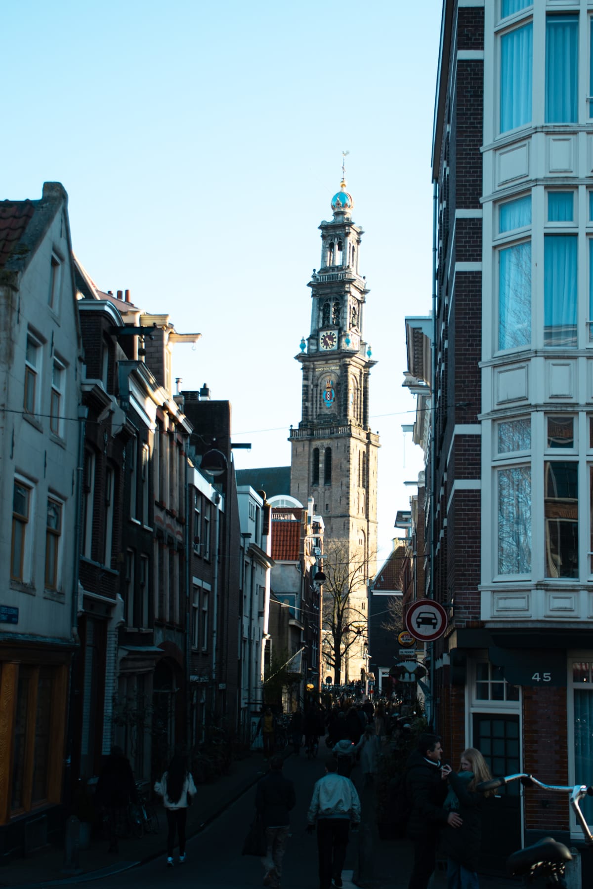 Amsterdam’s Westerkerk tower rising above a narrow crowded street