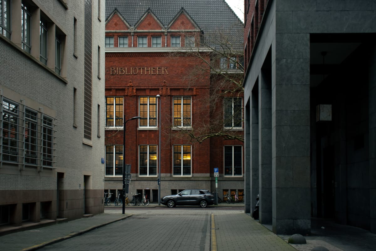 A red-brick library at the end of a narrow modern street
