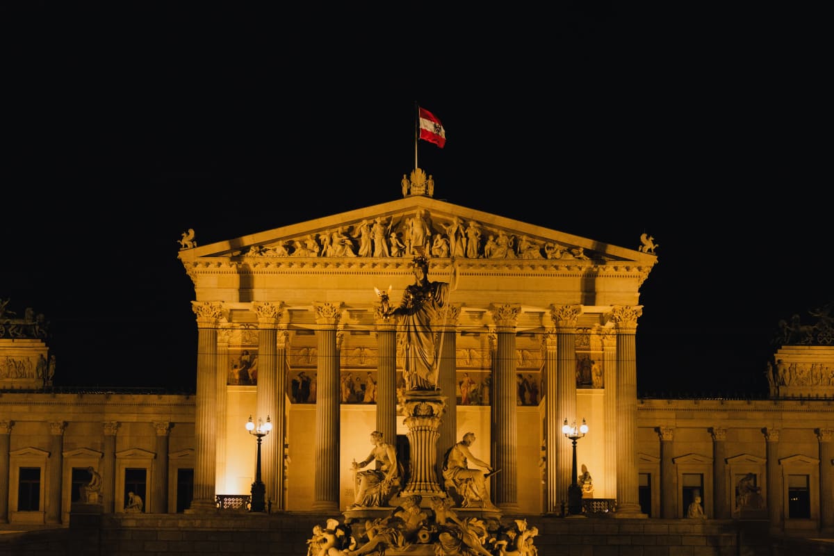The Austrian Parliament illuminated against the night sky