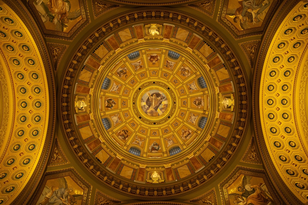 An ornate golden dome ceiling filled with painted figures