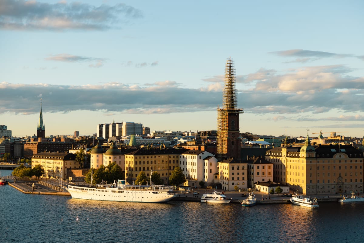 Historic Stockholm buildings and boats glowing across the water