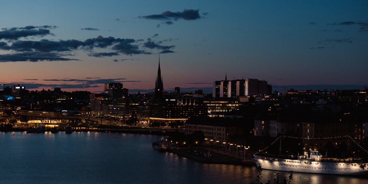Stockholm’s illuminated waterfront and harbour beneath a fading sunset