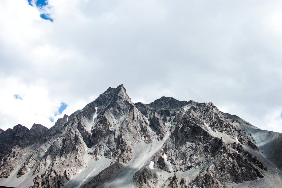 Rugged grey mountain peaks rising beneath pale clouds