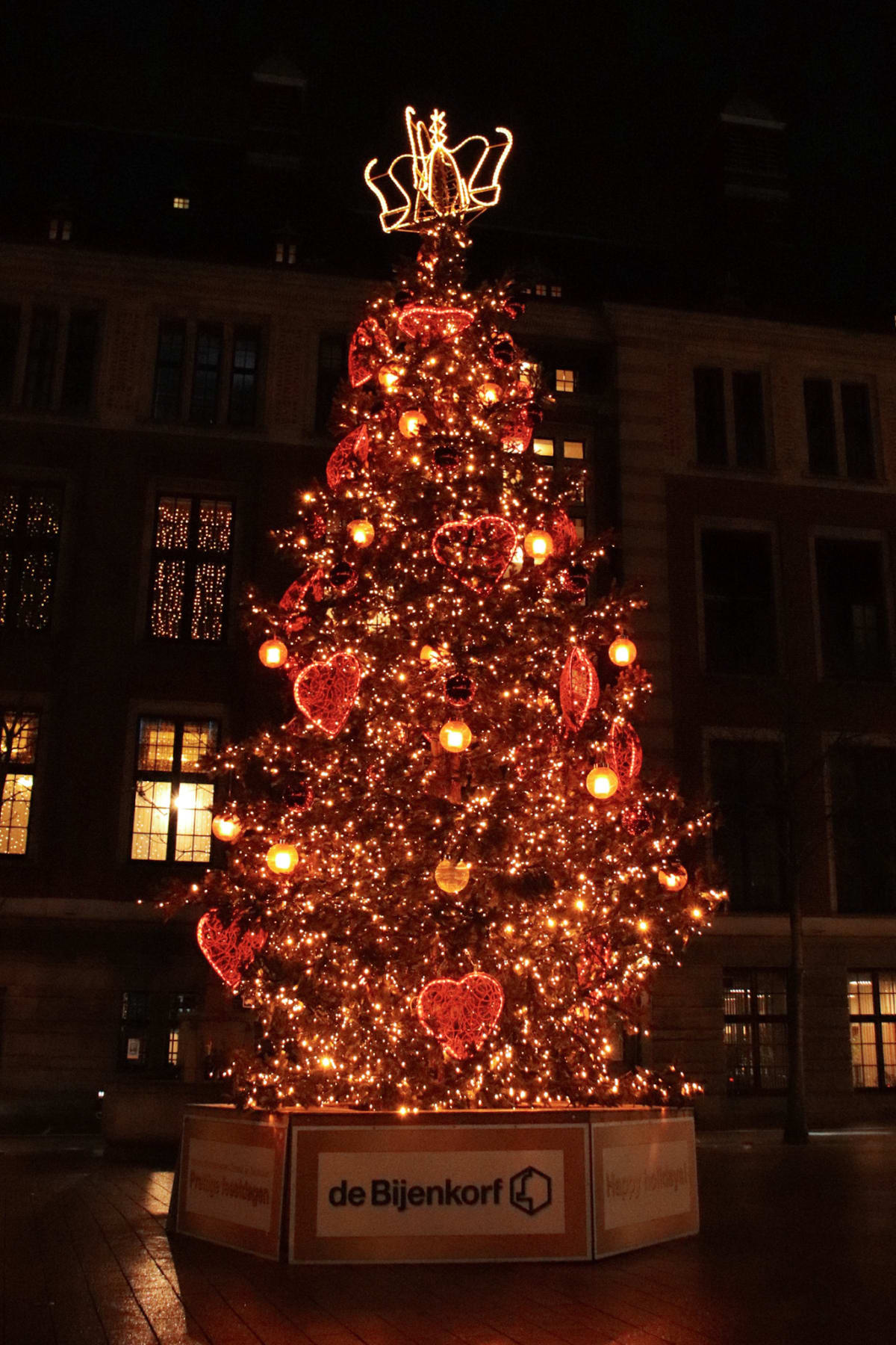 A Christmas tree covered in red hearts and golden lights