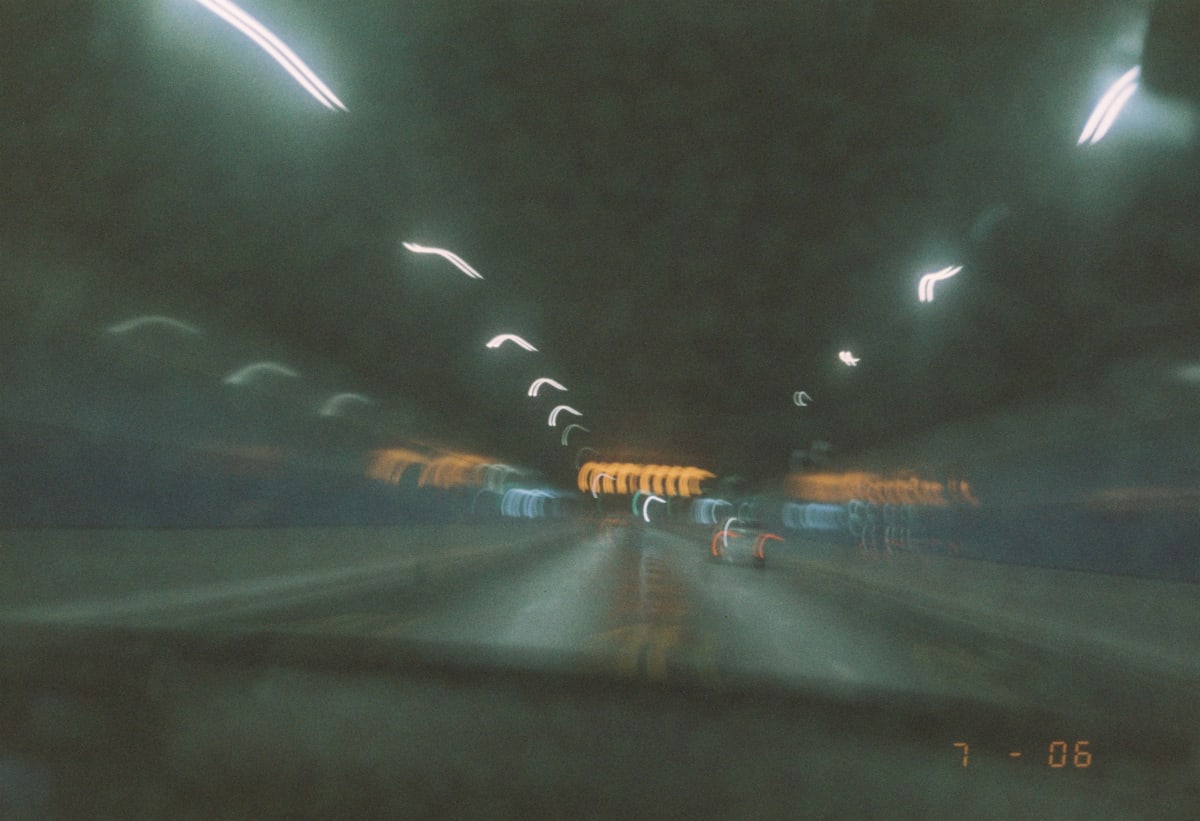 A blurred night drive rendered in streaks of light