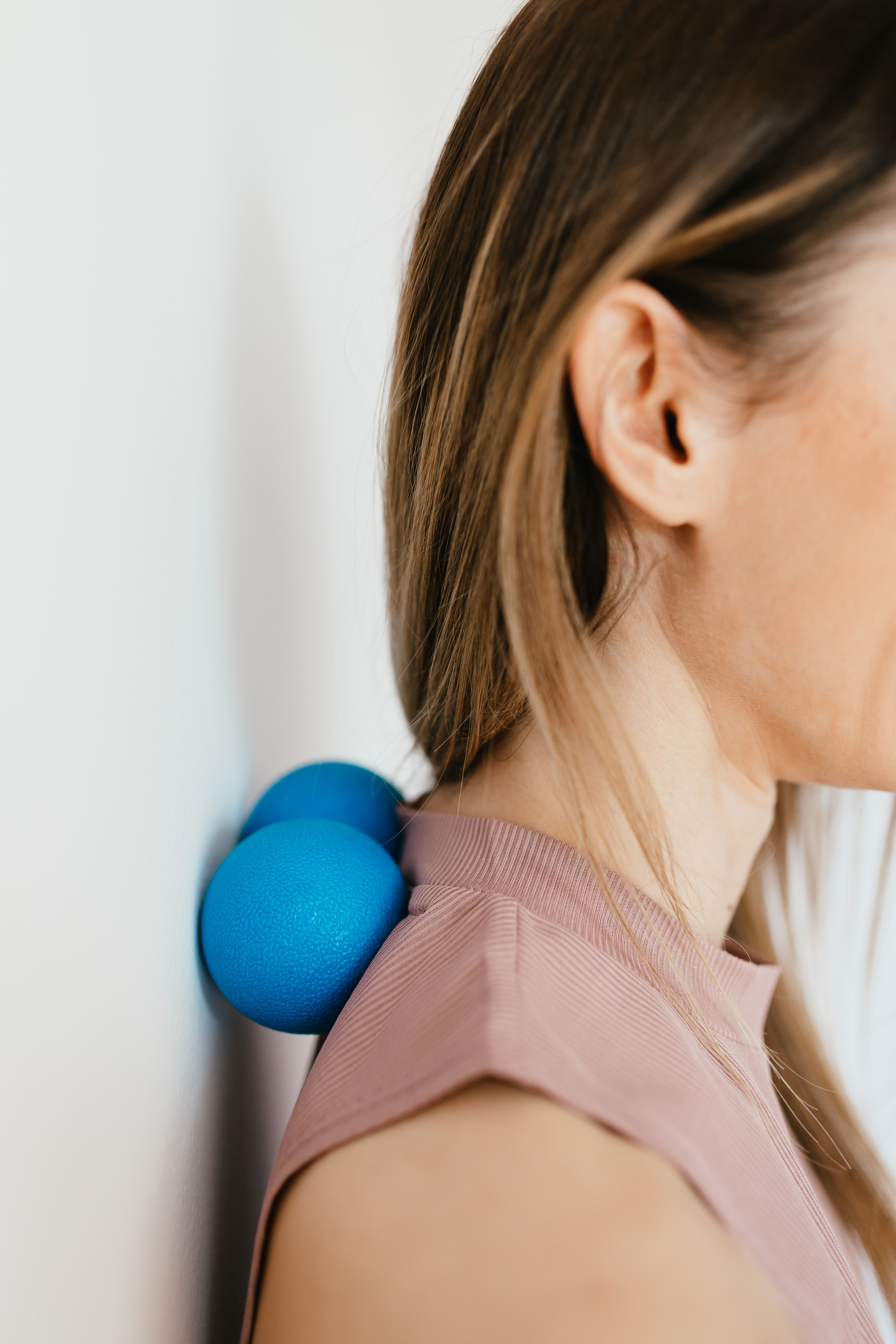 A trigger point massage ball used for muscle recovery in a small apartment.