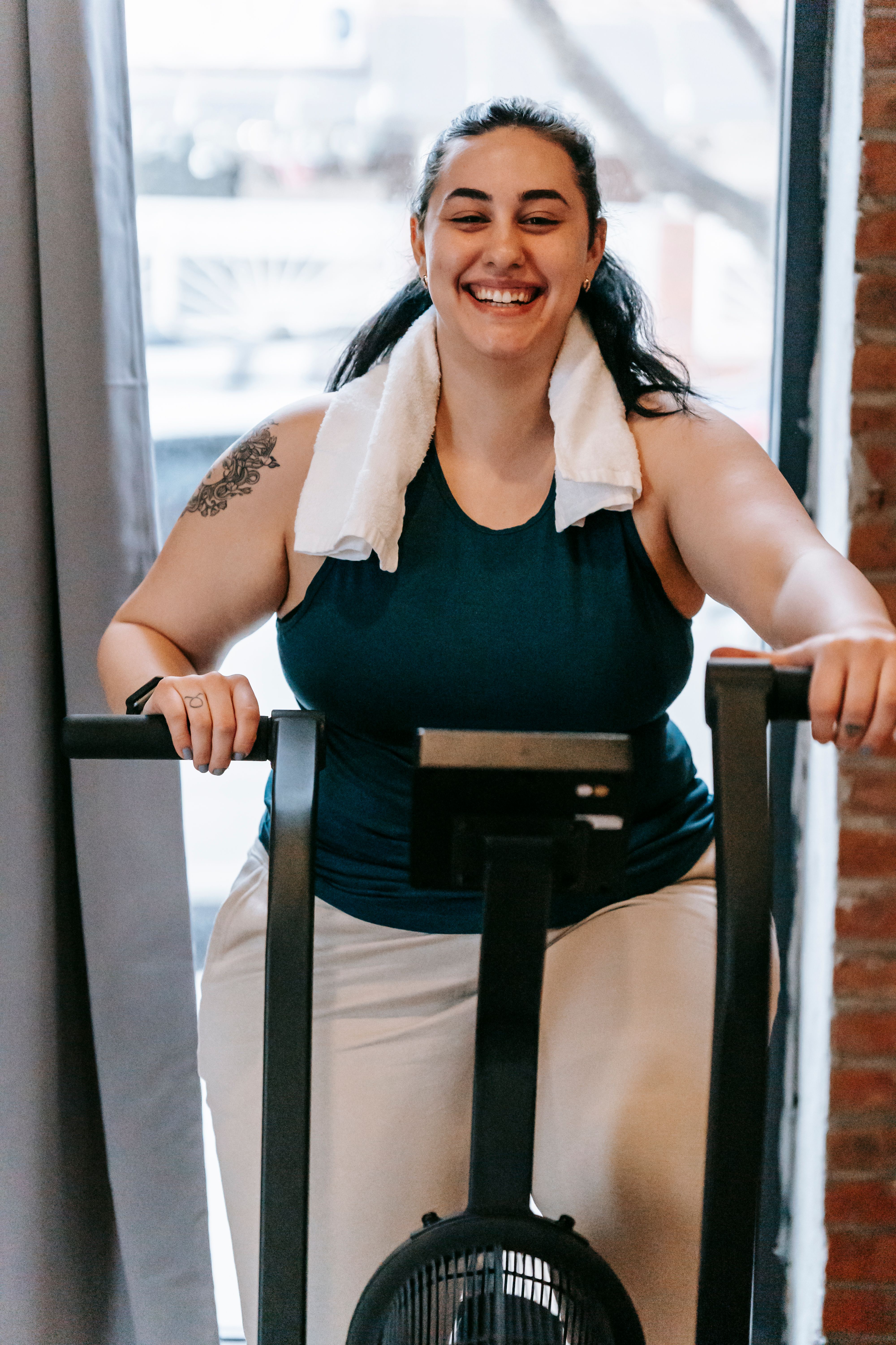 Person using a compact mini stair stepper exercise machine in a small apartment living room