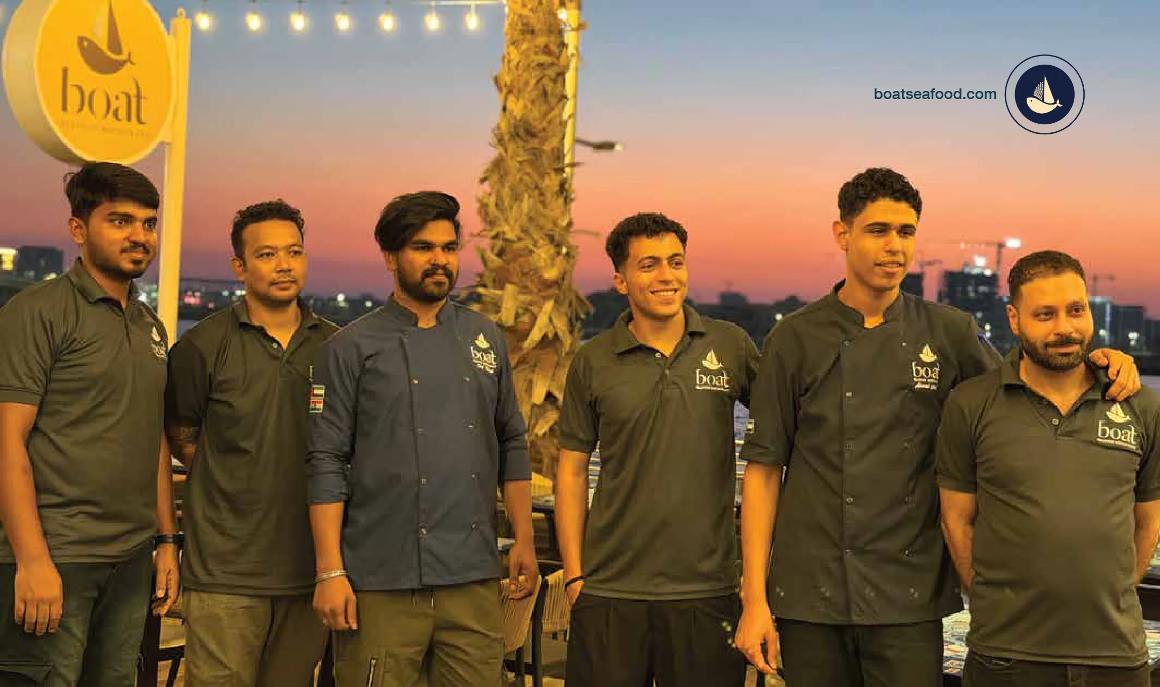The BOAT team at the waterfront at sunset