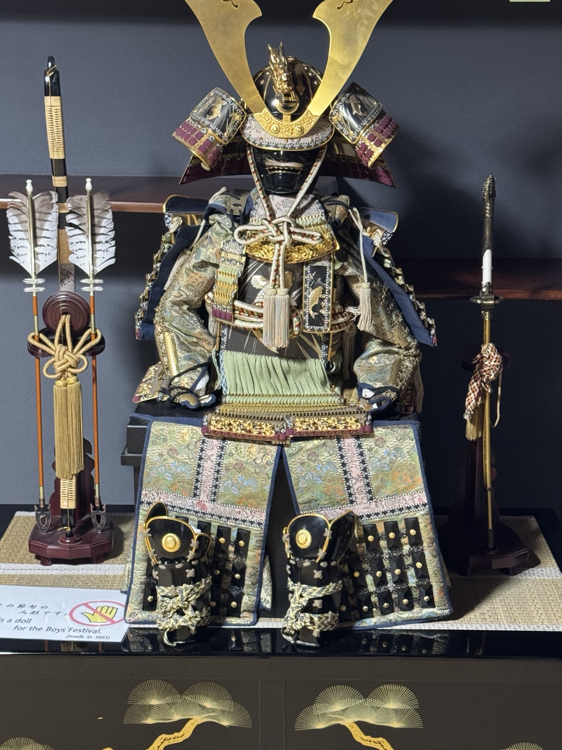 A samurai doll with an elaborate helmet and costume.