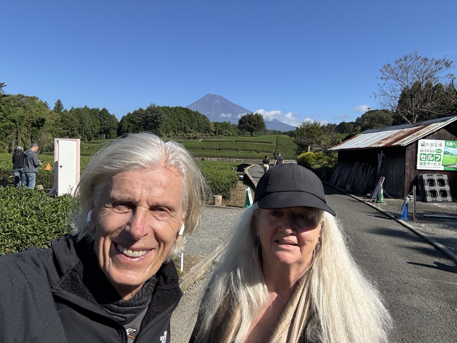 Kurt and Anneliese with Mount Fuji beyond a tea plantation.