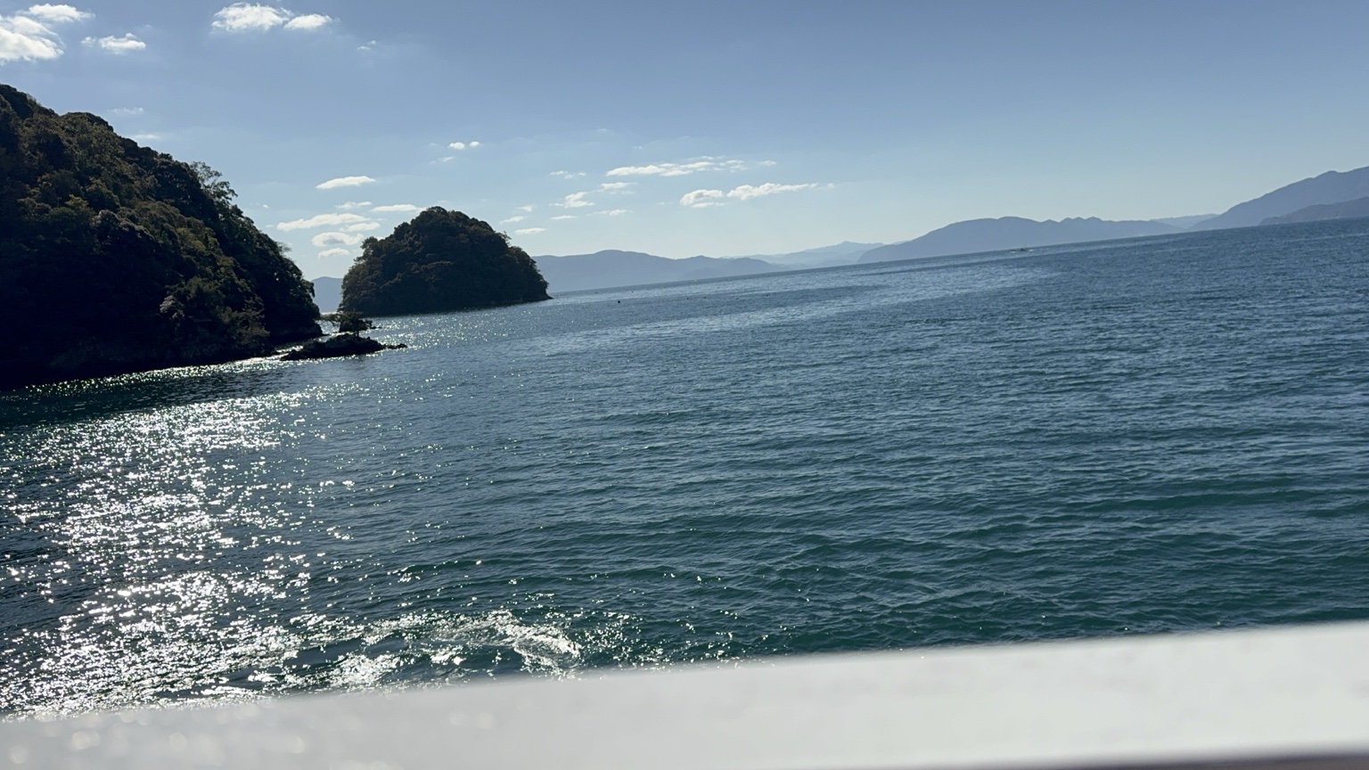 Sunlight on the water, with small islands beyond