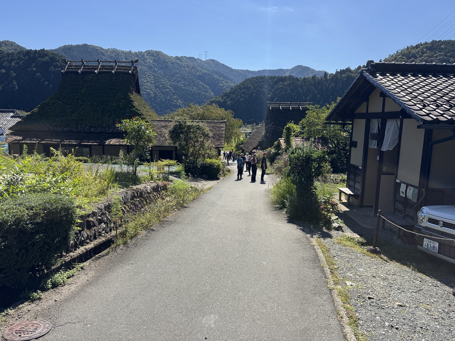 A lane between timber houses and thatched roofs