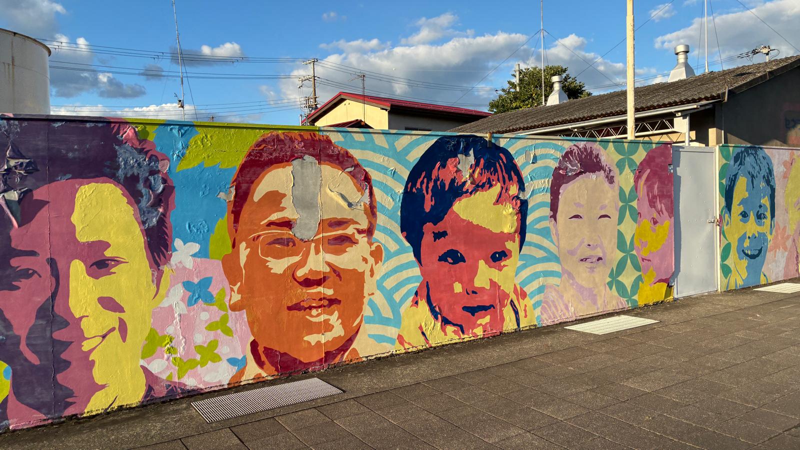 A wall of colourful portraits