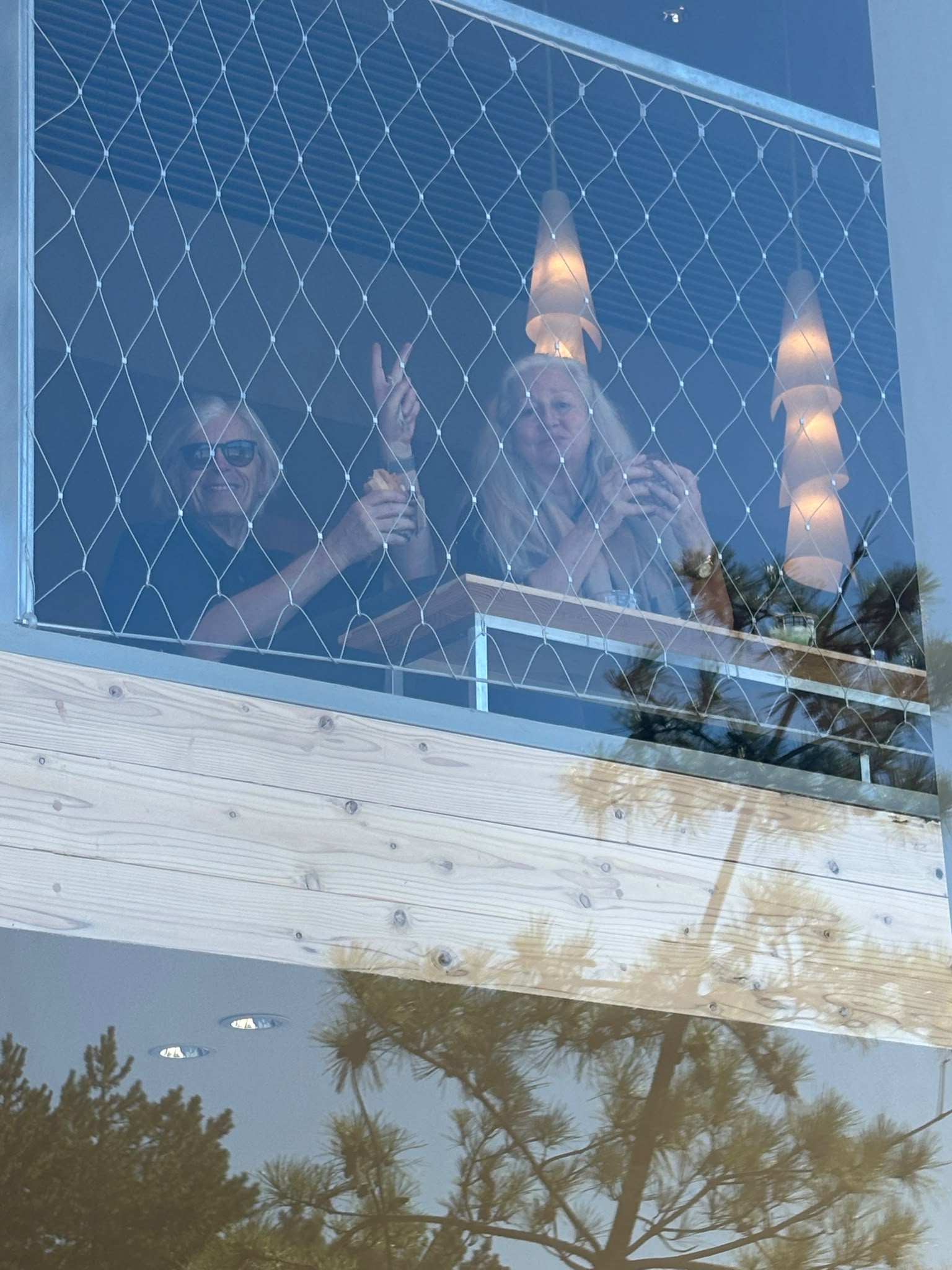 Figures and shapes behind glass, layered with reflections