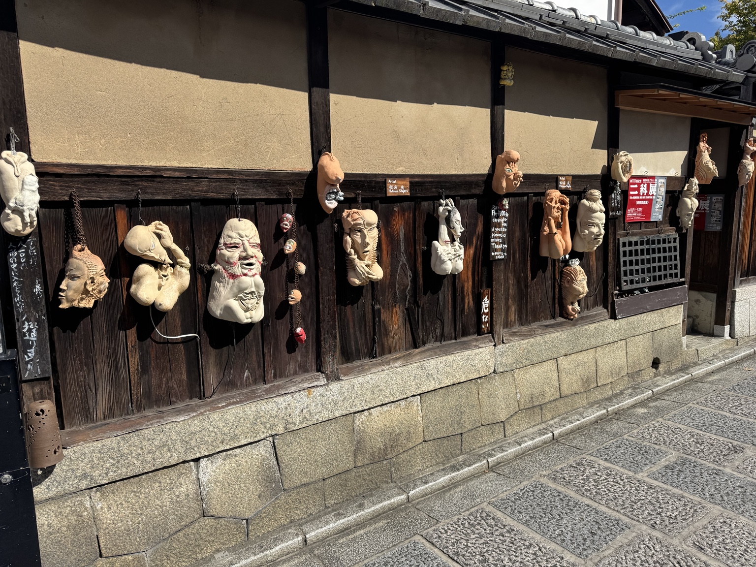 Masks and quirky figures on a wooden façade: Kyoto is full of small surprises.