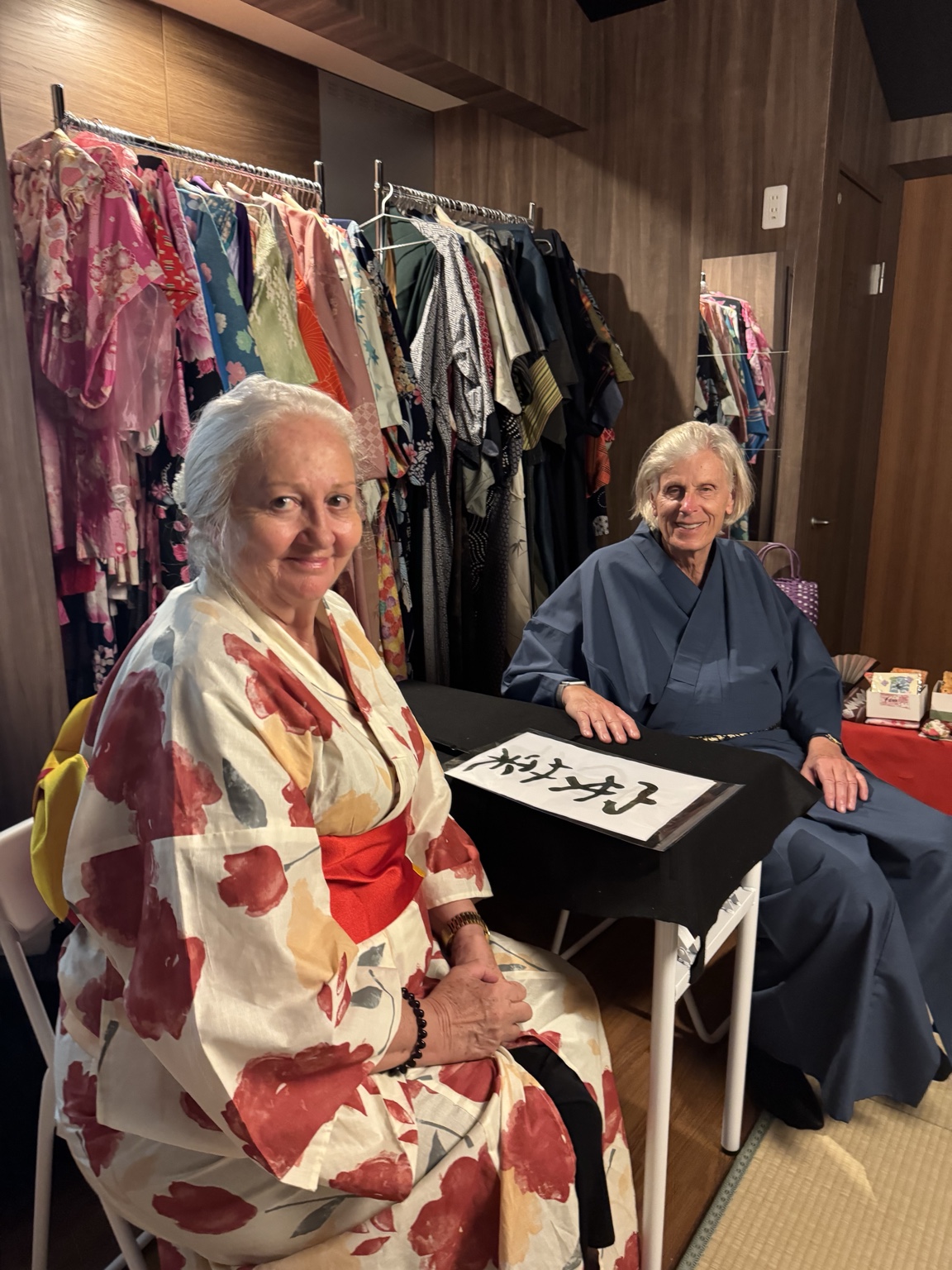 Anneliese and me in kimono, with a calligraphy sheet in front of us.