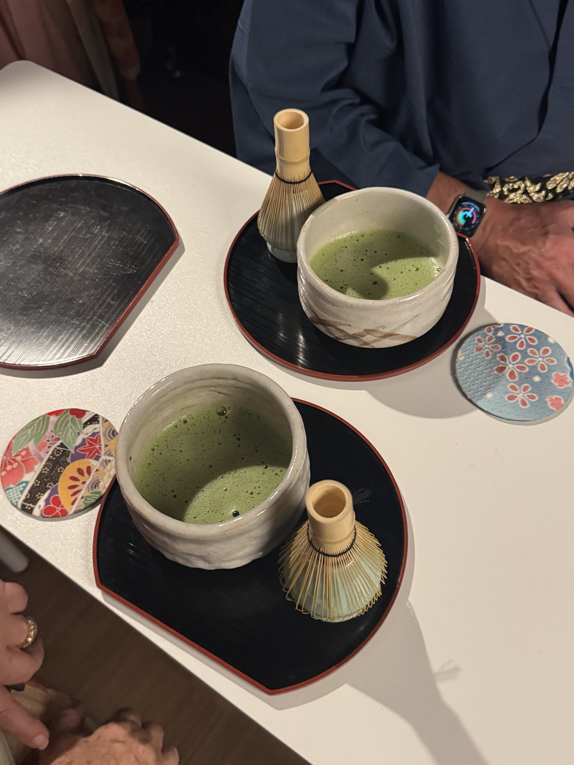 Two bowls of matcha and the bamboo whisks on our table.