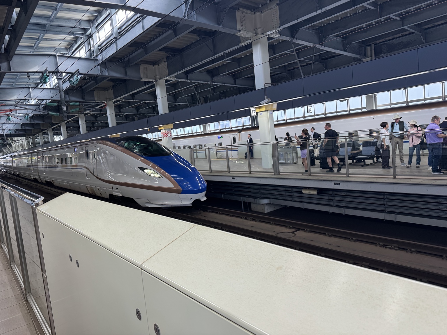 The Shinkansen arrives at the platform.