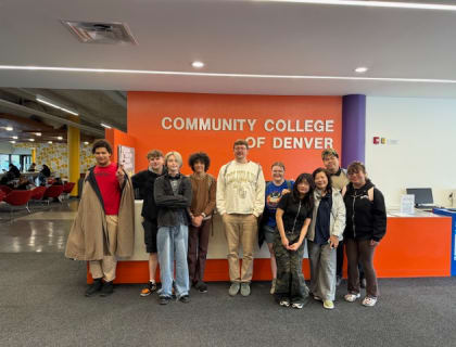 Students gathered beneath the Community College of Denver sign in the campus lobby