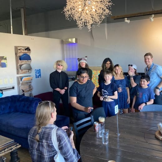 Students and staff gathered together indoors for the end of year celebration