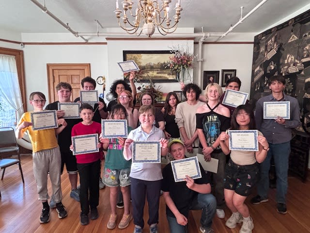 The full group of award recipients with their certificates