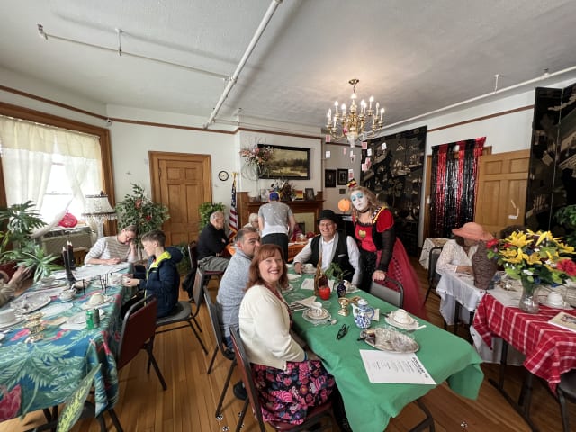 Long tables of guests set with flowers and place settings