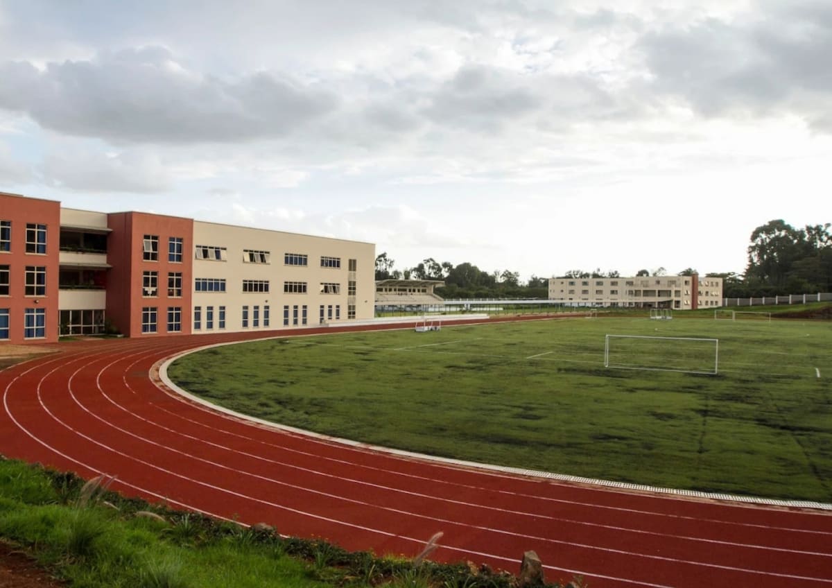 The 400-metre all-weather track curving around the playing field at Elyton, Karen