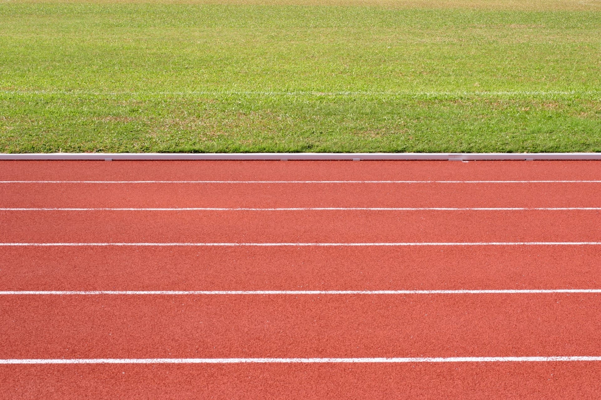 The 400-metre all-weather running track curving around the main building and playing field at Elyton, Karen