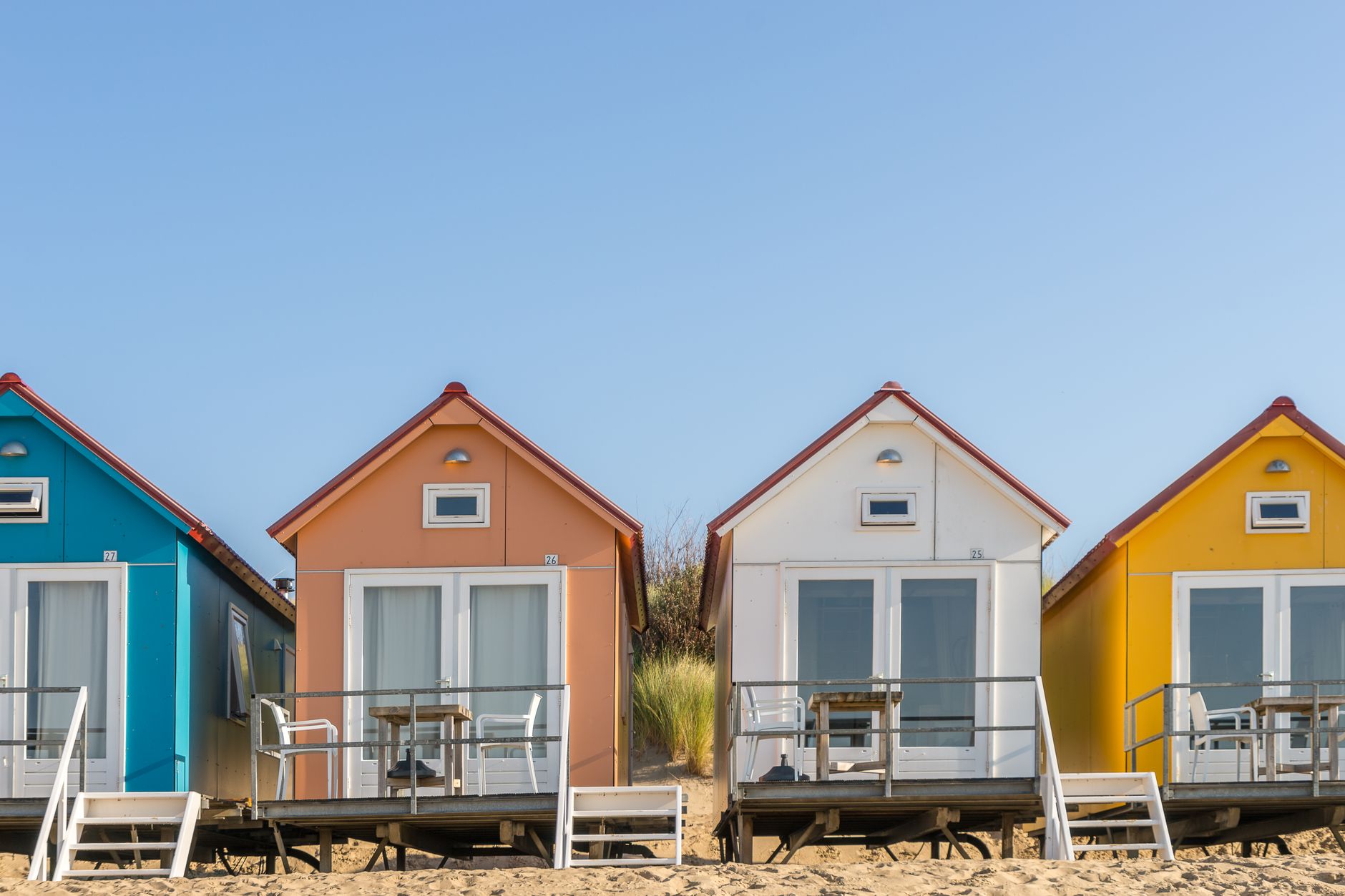 What are the benefits of buying a beach house this summer?
