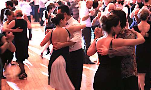 Couples dancing at a milonga event