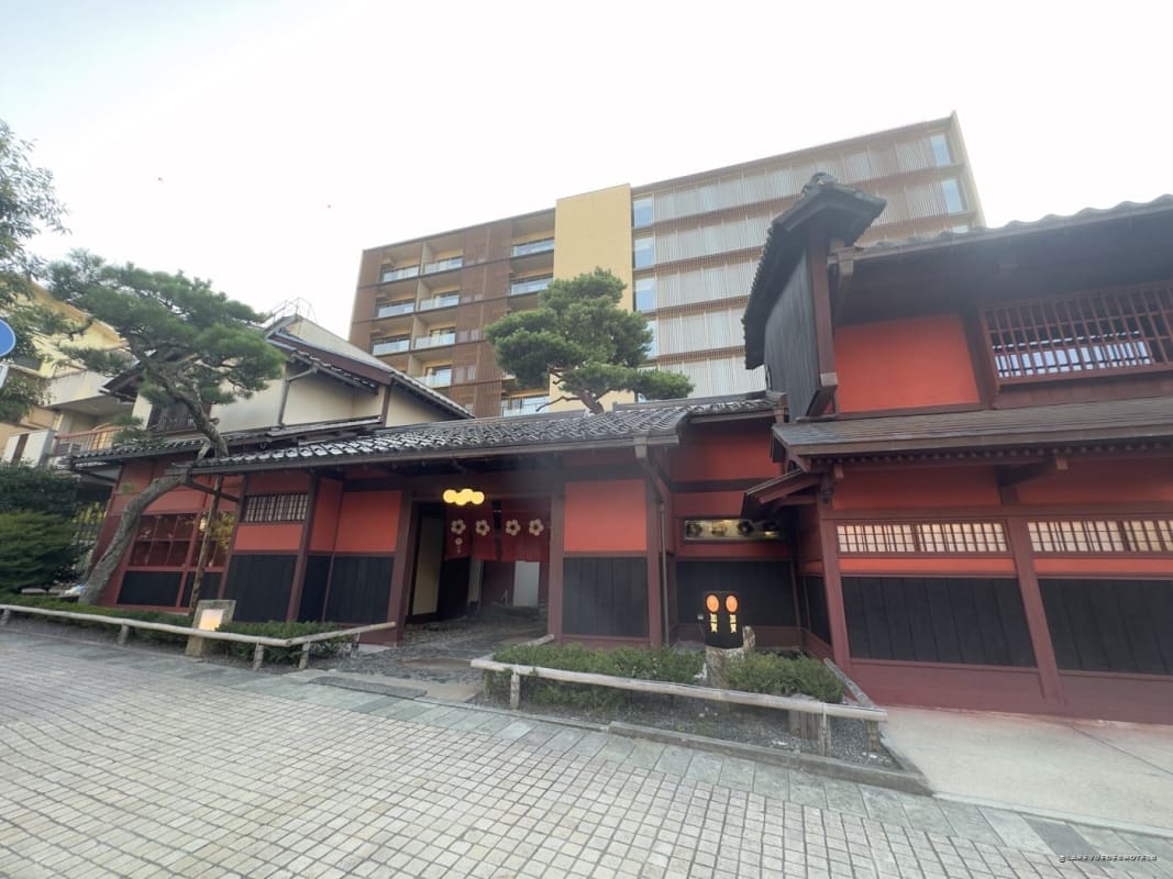 The wooden building of the KAI Kaga ryokan seen from the street