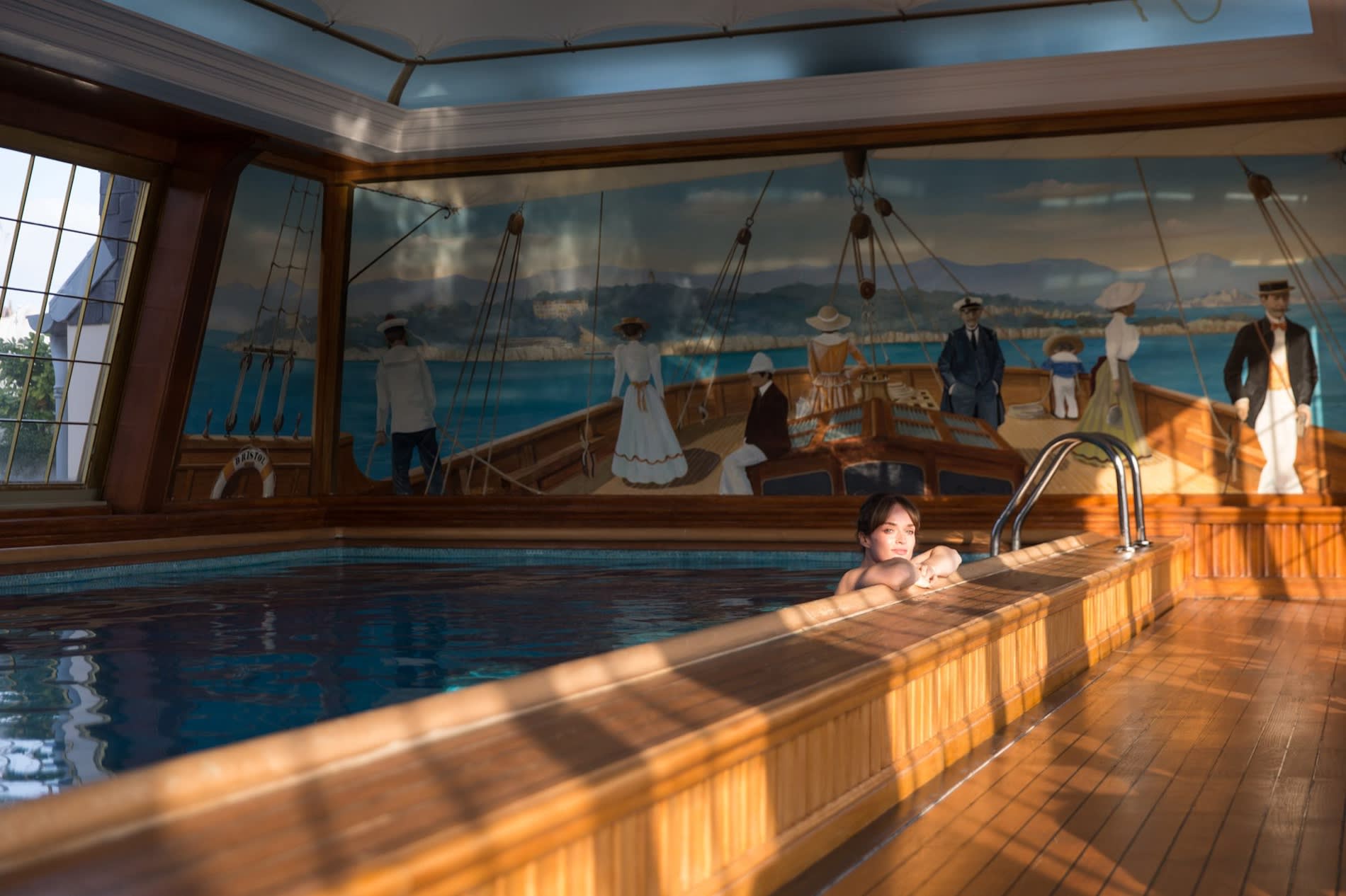 The teak pool at Le Bristol Paris, like a yacht deck, with its trompe-l'oeil fresco