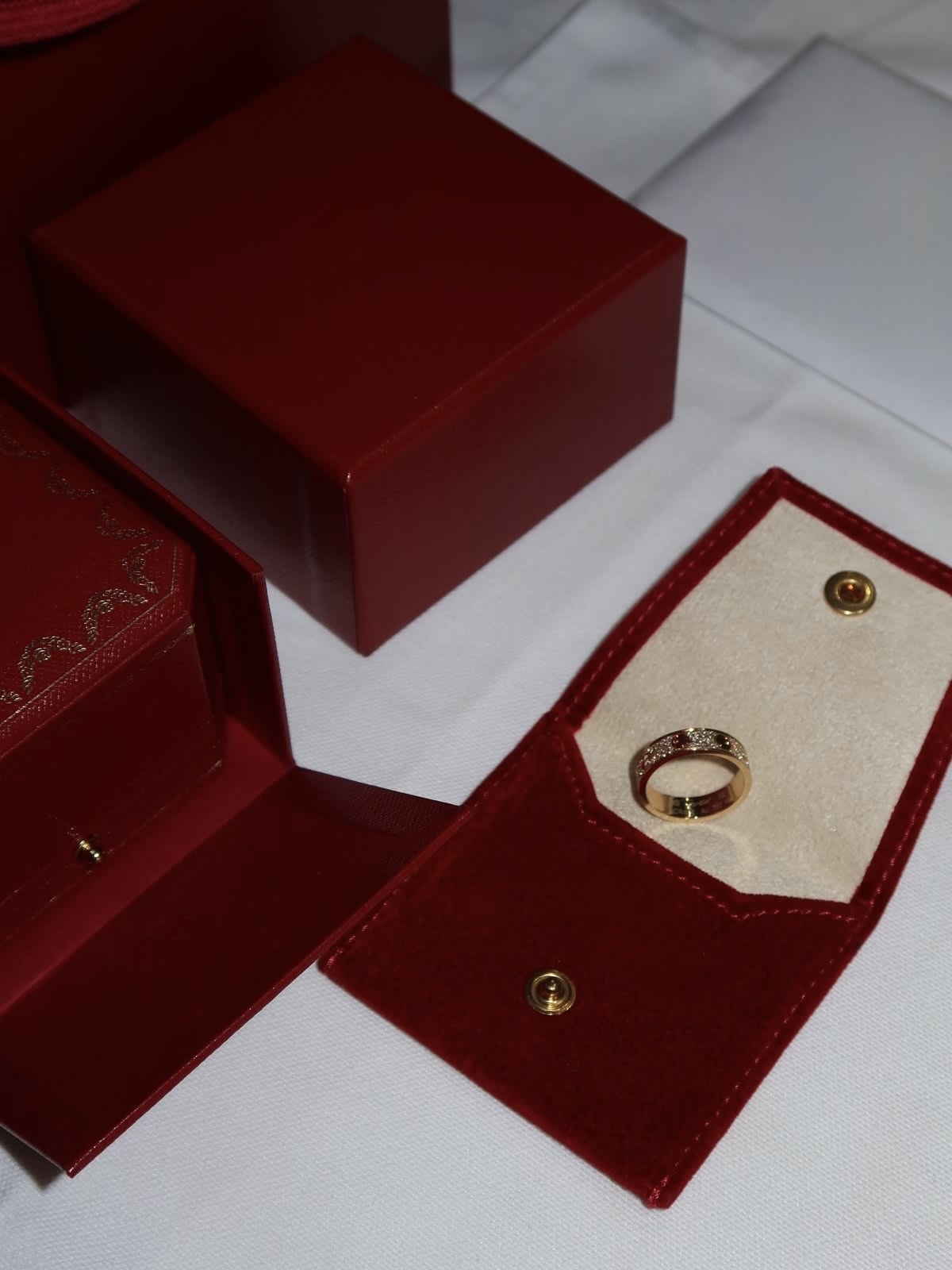 Rose gold Cartier Love ring with red Cartier pouch and box
