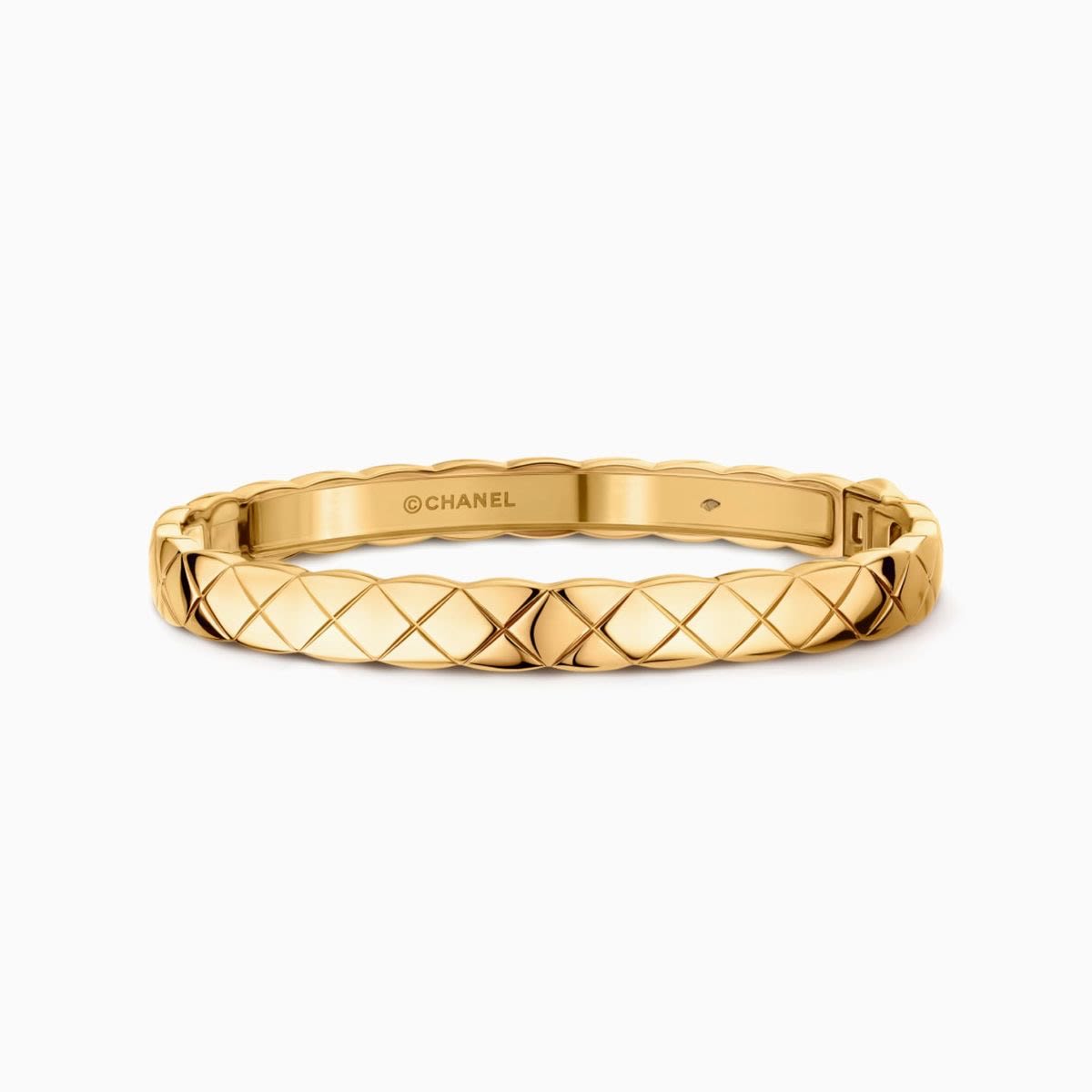 Gold quilted Chanel Coco Crush bangle on a white background