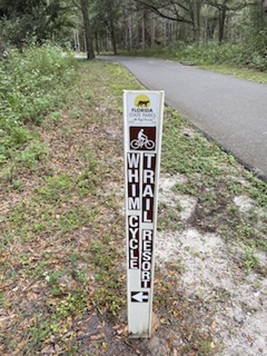 Whimcycle Trail wayfinding sign on paved trail