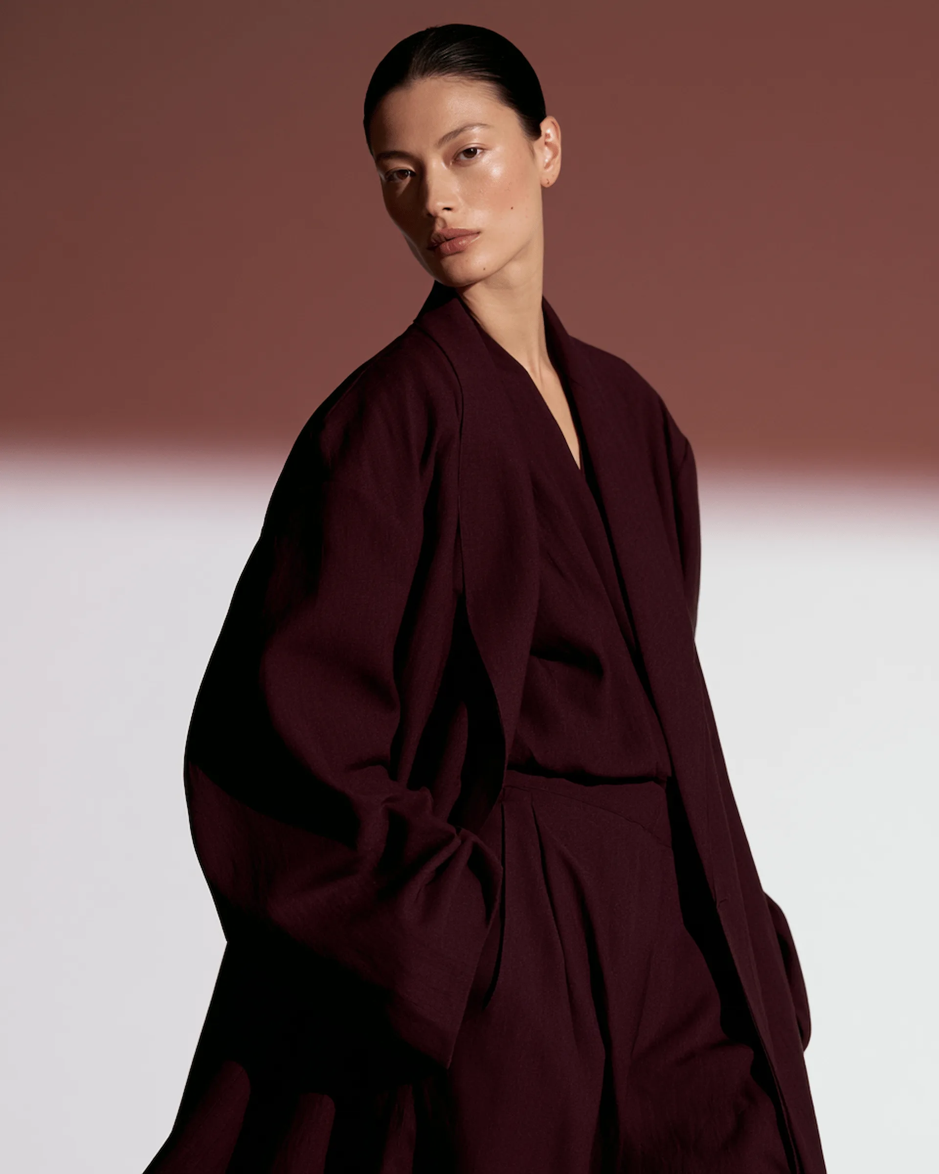 Editorial fashion portrait in a dark tailored outfit