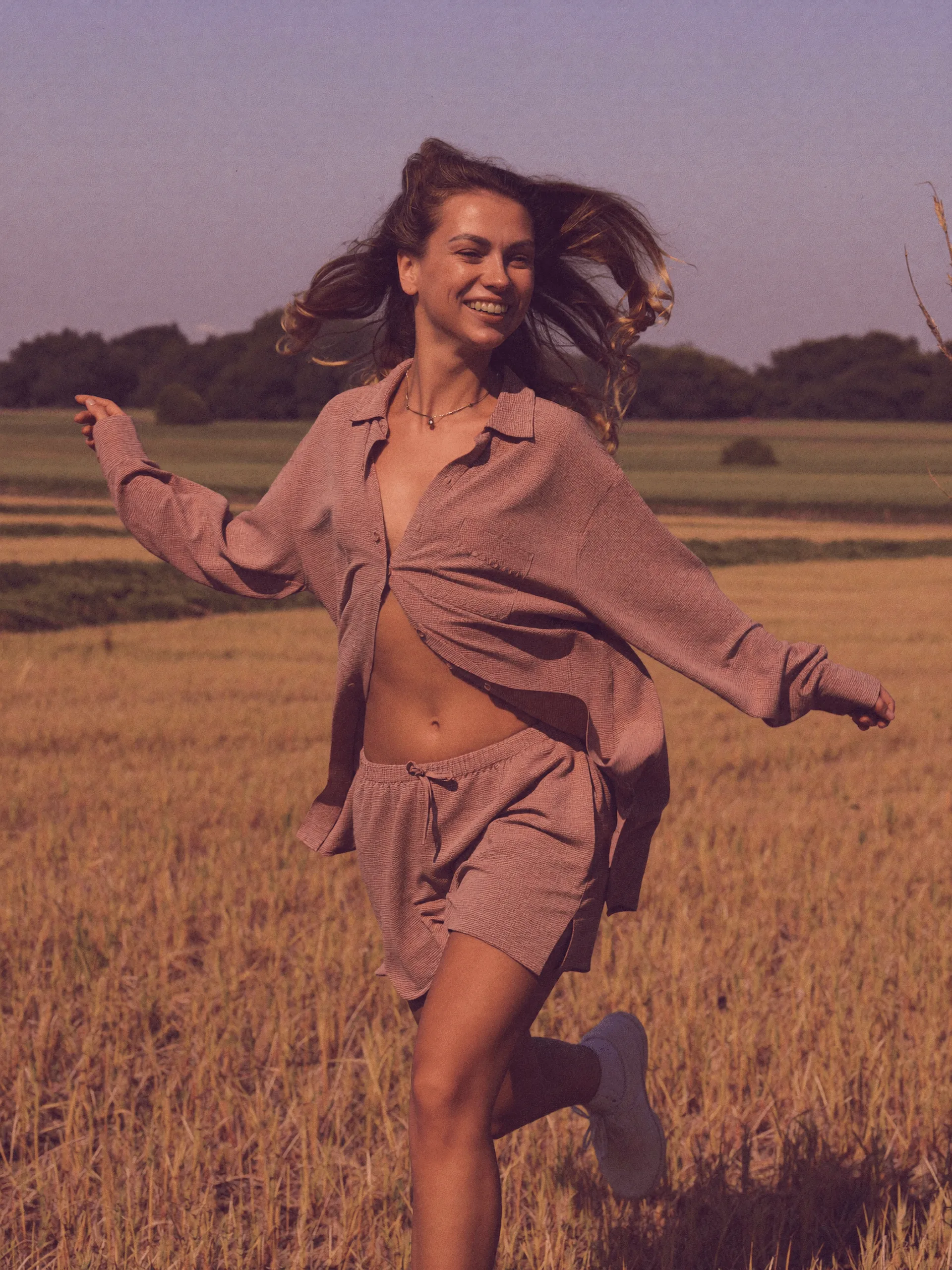 Julia Deychuk running through a sunlit field