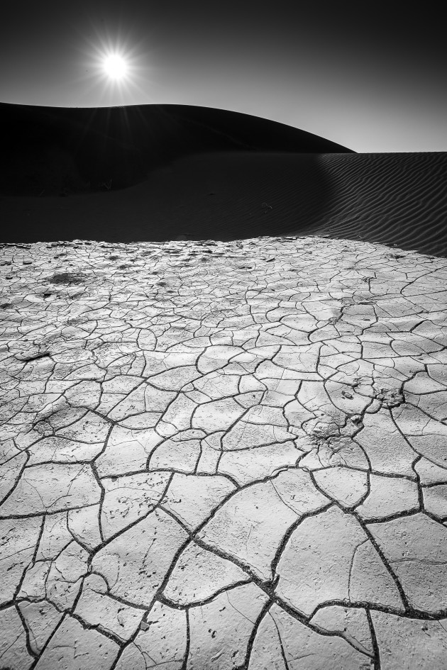 Shooting into the sun can open up a great deal of creative options - add a super wide angle lens like a 16mm on a full frame sensor or a 10mm on an APS-C sensor and you can easily spend well over an hour like I did shooting into a location like this! My goal here was to balance the clay patterns in the foreground with the dunes and an early sun. 16-35mm lens @ 16mm, 1/750s @ f11, EV to minus 0.5, ISO 200, handheld.