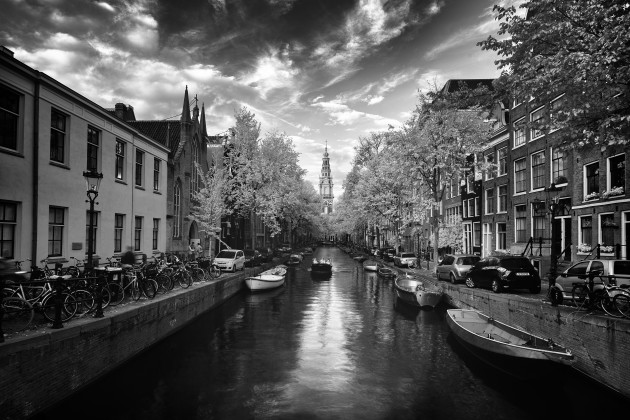 Amsterdam Canals, The Netherlands. Spending a day wandering around Amsterdam with my infrared camera was a thoroughly enjoyable experience. The clouds and light were looking just right when I shot this classic canal scene. Canon 5D Mark II converted to 720nm infrared, Canon TS-E 17mm f/4L, 0.4 seconds @ f9, ISO 100, tripod. Monochrome conversion in Silver Efex Pro, curves adjustments in Photoshop CC.