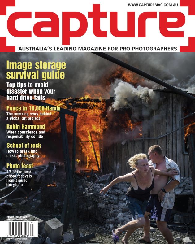 Civilians escape from a fire at a house destroyed by the air attack in the village of Luhanskaya, in Ukraine. © Valery Melnikov.