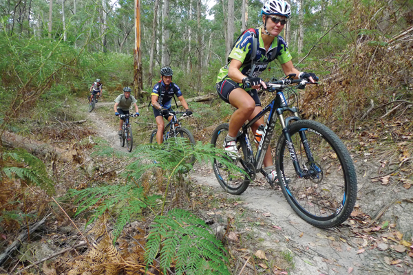 Local trail advocate Sharon Dilly leads the pack on the Sinkhole.