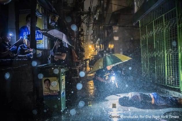 General News - First Prize, Stories. They Are Slaughtering Us Like Animals. Heavy rain pours as police operatives investigate inside an alley where a victim, Romeo Joel Torres Fontanilla (37) was killed by two unidentified gunmen riding motorcycles in the early morning in Manila, Philippines. © Daniel Berehulak, for The New York Times.