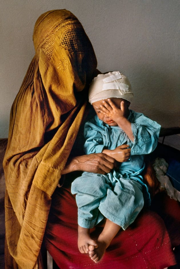 Kabul, 1992. A mother holds her two-year-old son, who was grazed by a stray bullet, at Karte Seh surgical hospital.