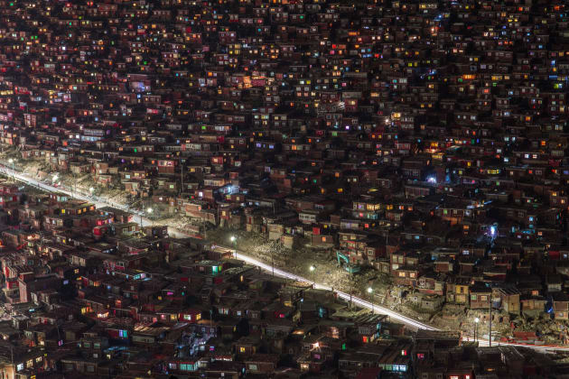 It is a Spectacular Seda Monastery called Larung Gar Buddhist Academy in China. It is famous of full mountain's red house. Despite its remote location, it grew from a handful of disciples gathering in Khenpo's home to be one of the largest and most influential centers for the study of Tibetan Buddhism in the world, numbering to nearly 10,000 monks, nuns, and lay disciples by the year 2000. However In 2016, reports emerged from Tibet that there was mass demolition drive by the People's Republic of China. The freedom of Monks are suppress. Copyright: © Ming Keung Tam, Hong Kong, Commended, Open, Architecture (open), 2017 Sony World Photography Awards