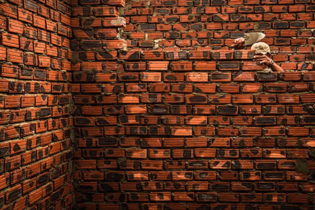 I was with a photo group when I found these men building a house out of bricks in a small fishing village near Hoi An, in Central Vietnam. The group continued ahead, no one stopped to observe this as a potential photo opportunity. I spent 5 minutes watching the men and how they moved. My vision was to create a sense of tension using the layers and textures of the brickwork, however an empty brick wall wasn’t the most interesting subject. The first three shots were very ‘straight’ or obvious that the men were building a house. As I observed the scene, I anticipated the moment when the man would disappear behind the wall to lay another brick, which added a point of interest within the detail. Isolating the foliage in the background and framing just the brickwork enabled me to draw the focus on the man for my final shot (main). Fuji X100S, fixed 35mm f/2 lens @ 35mm, 1/210s @ f4, ISO 800, handheld. Contrast, curves, saturation adjusted in Adobe Lightroom.