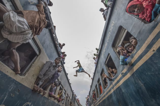 It was photographed at a train station in Bangladesh when the boy jumped accross from one train to another. Copyright: © Huizhen Liang, China, Commended, Open, Motion, 2017 Sony World Photography Awards.