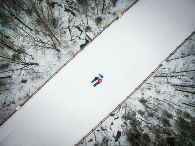 Dronie by Manish Mamtani. A bridge caked in snow in New Hampshire was the perfect opportunity for Manish Mamtani and his wife, both wearing bright clothing, to create a contrasting “dronie” (selfie taken by drone) against the monotonous white winter cold.