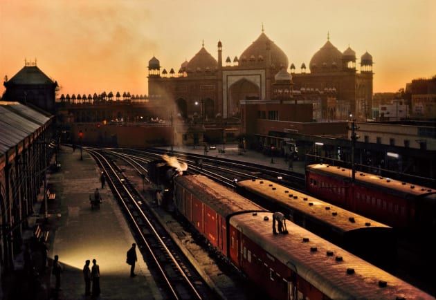 Train Station, Agra, India, 1983. In this shot McCurry has captured Agra’s train station during the ‘golden hour’. Originally this was a term used by cinematographers to denote that time of day when the setting or rising sun casts everything in a rich golden light. It’s a quality that brings an opulence to a scene. Copyright Steve McCurry.