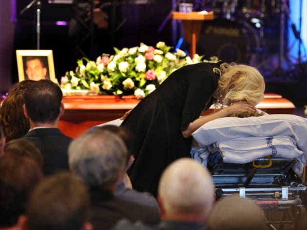 “Close your eyes, I love you”. It’s a rare and heartbreaking sight — a son wheeled in on a stretcher bed to his father’s funeral. The service was delayed so that 17-year-old Brendan Powell could attend from hospital after being injured in a crane collapse at Newstead that killed his father, aerial photographer Chris Powell. © Annette Dew.