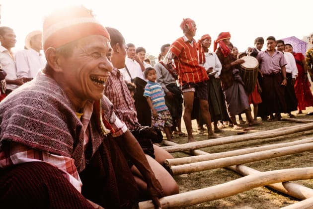 A man rhythmically claps bamboo sticks together for the Chin bamboo dance. Fujifilm X-T1, 16mm f/1.4 WR lens, 1/220s @ f/7.1, ISO 500. Classic Chrome film simulation, white balance and sharpness adjusted in Lightroom.